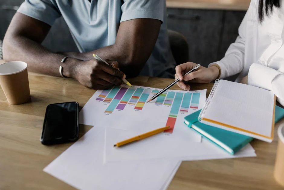 Close-up of SEO strategy planner with colorful sticky notes and a pencil on a notebook.